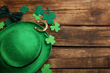 Flat lay composition with leprechaun hat on wooden table, space for text. St Patrick's Day...