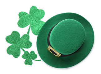 Leprechaun's hat and decorative clover leaves on white background, top view. St. Patrick's day...