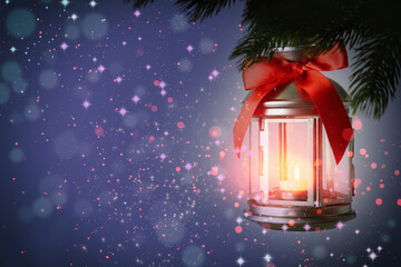 Christmas lantern with candle hanging on fir tree branch, space for text. Magical atmosphere