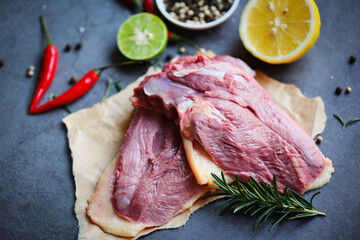 Fresh duck meat for food, Raw duck breast with herb spices ready to cook on wooden cutting board.