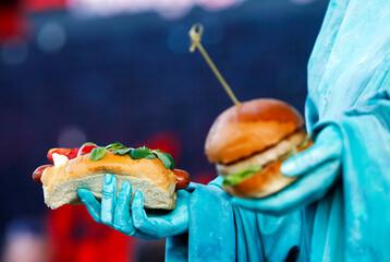 hamburger and hot dog closeup in painted like the Statue of Liberty woman, fast food concept