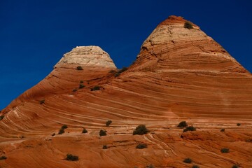 Textured sandstone red buttes under the blue sky. Utah and Arizona states of Southwest. United States of America