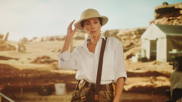 Portrait of Beautiful Female Adventurer Posing and Looking at Camera. Stylish Great Archaeologist Standing with Ancient Civilization, Fossil Remains Archeological Site, Forgotten City in Background