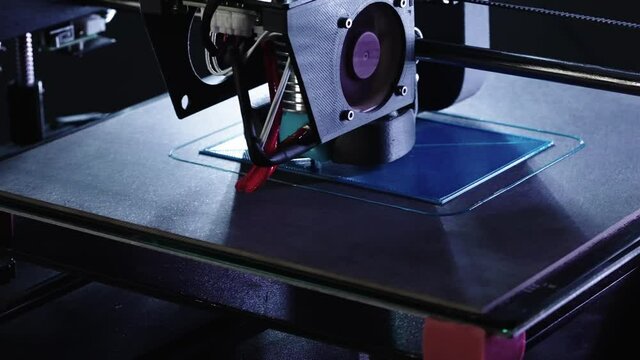 Zoom in close up of 3d Printer printing blue house shot in 4k