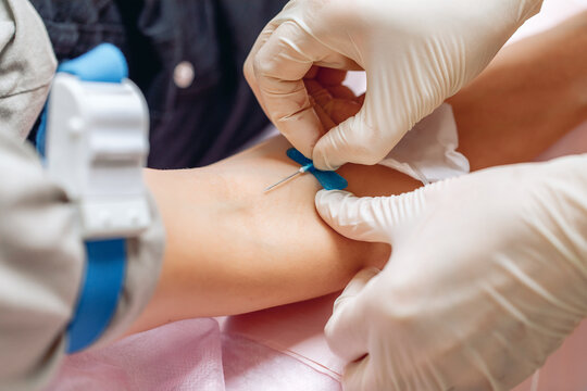 Nurse taking blood from a vein from a patient close up. Health and care. Dropper. Health concept