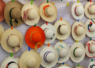 Colorful Handmade straw Panama Hats or Paja Toquilla hats or sombrero at the traditional outdoor market in Cuenca, Ecuador. Popular souvenir from South America