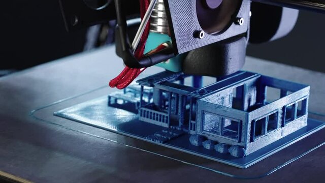 Zoom in close up of 3d Printer printing blue house shot in 4k