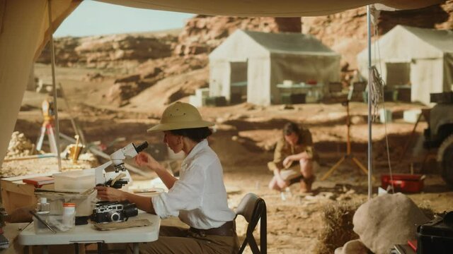 Archaeological Digging Site: Great Female Archaeologist Doing Cultural Research, Discovers Ancient Civilization Historical Artifacts, Fossil Remains at Excavation Site, Study it Under Microscope