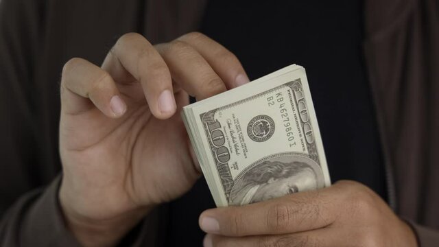 Close up male hand Counting money us dollar. Financial business concept.
