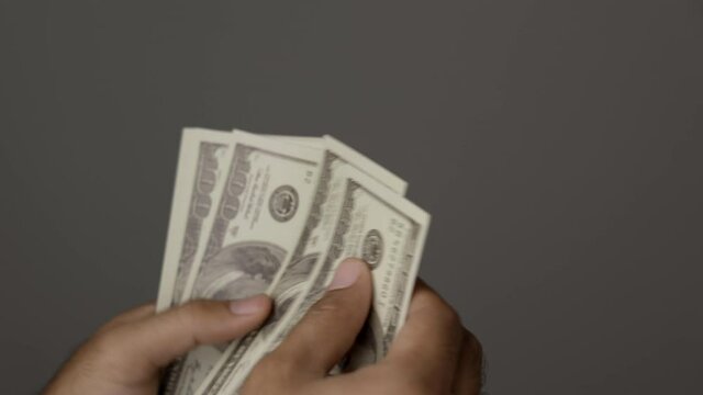 Close up male hand Counting money us dollar. Financial business concept.
