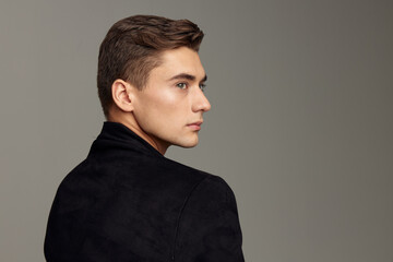 Fototapeta premium handsome man standing back fashionable hairstyle posing cropped view