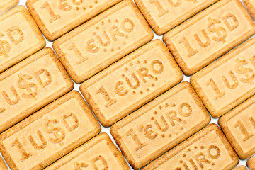 Textured sugar cookies with the 1 USD and 1 EUR currency symbols ,diagonally, background.