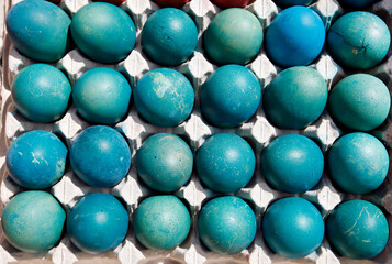 egg, green and blue eggs in a carton. closeup