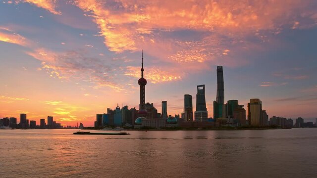 On June 29, 2019 in Shanghai, China. Time-lapse of Lujiazui Financial District in Pudong at sunrise. The Huangpu River and Oriental Pearl TV Tower