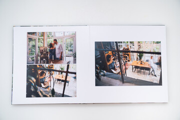 pages of photobook from photo shoots of a beautiful happy couple in retro house.