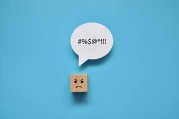 A wooden cube with an angry face and the inscription: I am angry. The person is angry and talks...