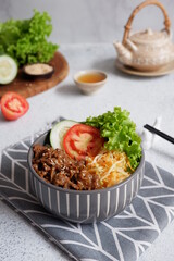 beef teriyaki rice bowl with vegetables in a white background
