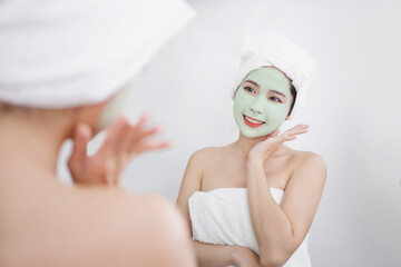 Asian woman use a facial mask. She was relaxed and happy.