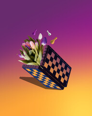 Chess board and tulips on a yellow-pink gradient background. Creative concept of marketing strategies 