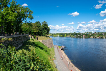 Fototapeta na wymiar Old bastions and park along the Narva Promenade by the Narva River in eastern Estonia by the Russian border