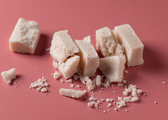 hand made salt soap cut into pieces on coral background