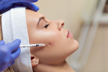 Skin rejuvenation and nourishment procedure. A needle and syringe are used to inject nutrients into the skin. Personal and skin care. Beauty concept