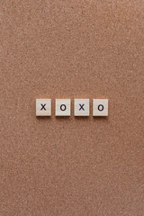 xoxo wooden letters on cork board