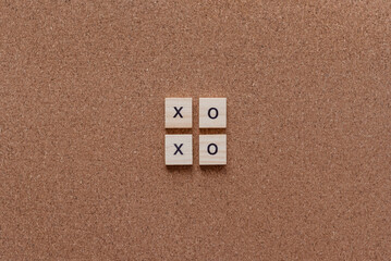xoxo wooden letters on cork board