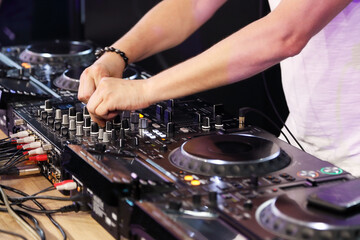 Fototapeta na wymiar DJ playing music on digital mixer controller