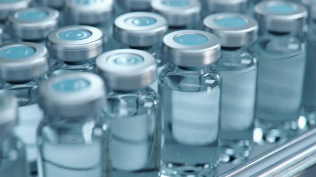 No Logo Vaccine Mass Production in Laboratory, Transparent Bottles without Labels Move on Pharmaceutical Conveyor Belt in Research Lab. Medicine Against Covid-19, Loopable Footage.