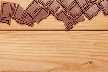 broken brown chocolate bar and background image texture top view