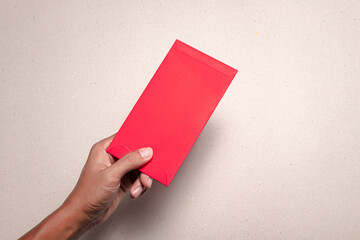 man's hand hold with chinese red envelope,on white background