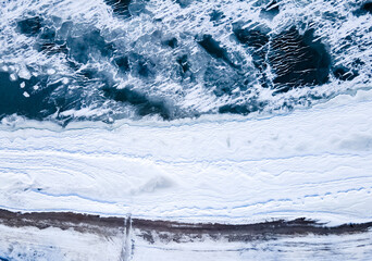 Aerial view of frozen seashore. Ice from drone view. Background texture concept.