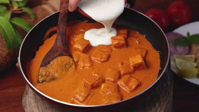 Paneer butter masala , Paneer tikka masala curry Delhi Mumbai North Indian vegetarian side dish  Cooking butter paneer made using cottage cheese, Indian spices 4K slow motion video, footage Kerala, 