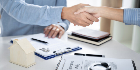 Business meeting Handshake. home loan insurance. .Real estate broker and client  sign contract insurance agreement document.