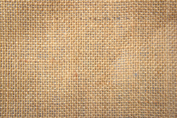 Jute hessian sackcloth canvas woven texture pattern background in light beige cream brown color blank empty
