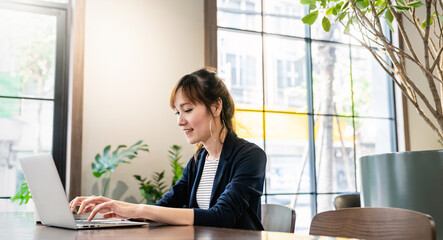Portrait of smiling beautiful business asian woman in suit working in office desk virtual computer. Small business people employee freelance online sme marketing e-commerce telemarketing concept