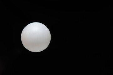 On a black background, a tennis ball. Concept Game. Copy space