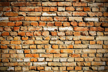 Brick wall background with slight vignetting. Grungy wall texture.
