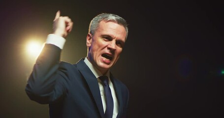 Aggressive man speaking about politics from stage