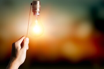 Hand turning off the bulb lamp.Turning off the light.