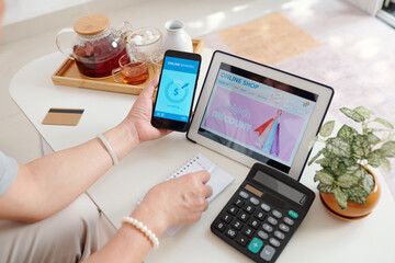 Hands of senior woman shopping in online store on sale and paying for purchases with mobile application