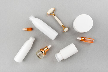 Skin and body care spa set on abstract gray background. Anti aging and acne massage routine. Top horizontal view copyspace.