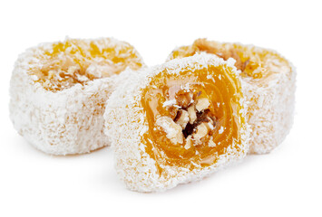 Yellow Turkish Delight with nuts in powdered sugar isolated on white