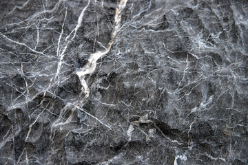 Obraz na płótnie Canvas Grey stone surface with white veins ornament. Distressed stone surface. Rustic material template. Grey mineral surface