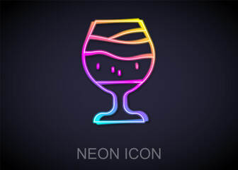 Glowing neon line Glass of beer icon isolated on black background. Vector.