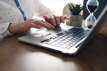Female young hands with manicure typing text on laptop. Working with laptop at home. Close-up.