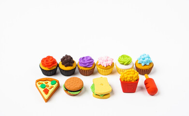 View of miniature toy kitchenware and foods on white background. Image with selective focus and flat lay.