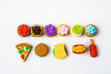 View of miniature toy kitchenware and foods on white background. Image with selective focus and flat lay.