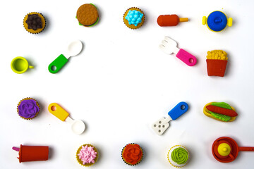 View of miniature toy kitchenware and foods on white background. Image with selective focus and flat lay.